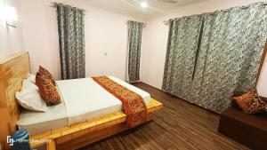 a bedroom with a bed and windows with curtains at Moonshine Home stay in Srinagar