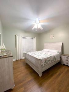 a bedroom with a bed and a ceiling fan at Spacious Home near Gulf Shores & Orange Beach in Foley