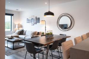a living room with a table and a couch at Revylation by Revelstoke Vacations in Revelstoke