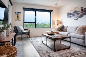 a living room with a couch and a table at Revylation by Revelstoke Vacations in Revelstoke