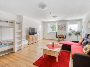 a living room with a red couch and a bunk bed at Elegant Appartment in Freiburg im Breisgau