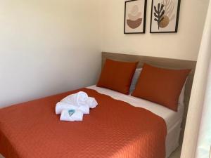 a bedroom with a bed with towels on it at Pousada Artelai in Angra dos Reis