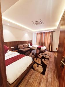 Habitación de hotel con cama y sofá en AERO HOTEL BY AERO LOUNGE AND BAR en Katmandú