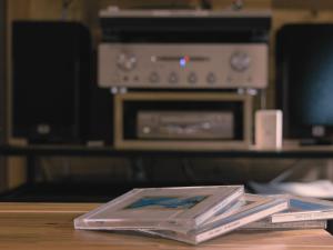 a stack of books sitting on a table with a stereo at Azumino Salon in Azumino