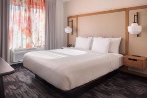a hotel room with a large bed and a window at Fairfield Inn by Marriott New York LaGuardia Airport/Flushing in Queens +12 photos
