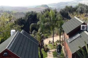 an aerial view of a house with solar panels on its roofs at בקתות עץ סקנדינביות במטולה in Metulla +12 photos