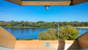 a view of a lake from a window at Apartament z pięknym widokiem in Nowy Dwór Mazowiecki