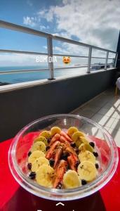 a plate of food on a table with bananas and meat at Apartamento Iracema Fortaleza in Fortaleza