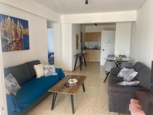 ein Wohnzimmer mit einem blauen Sofa und einem Tisch in der Unterkunft Galtheo in Lachi
