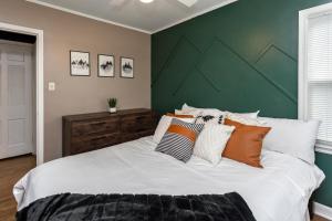 a bedroom with a large bed with a green wall at Near Drake/Downtown packed w/Amenities - Hot Tub - Movie Theater in Des Moines