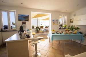 a kitchen with a table with food on it at B&B Celestina Ischia in Lacco Ameno
