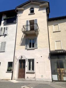 a large white building with a balcony and a door at Casa Alta in Lugano