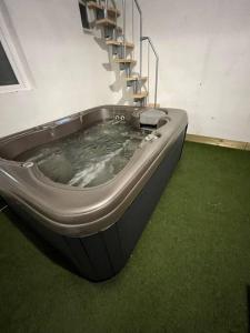 a hot tub in a room with a staircase at Maison Jaccuzi et salle cinéma in Lyon