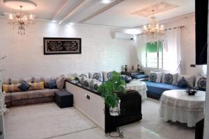 - un salon avec un canapé et une table dans l'établissement Appartement traditionnel marocain & spacieux, à Fès