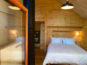 a bedroom with a large bed and a bath tub at LA CÀ NOVA. South Switzerland cozy gate away. in Osco