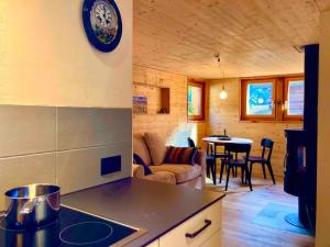 a kitchen and living room in a log cabin at LA CÀ NOVA. South Switzerland cozy gate away. in Osco