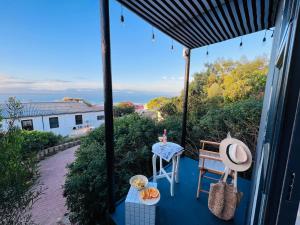 a view of a porch with a bench and a table at The Bachelor in Mossel Bay