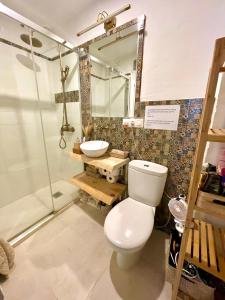 a bathroom with a toilet and a sink and a shower at Arcos de Tarifa, Casco historico in Tarifa