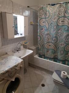a bathroom with a sink and a toilet and a shower at Georgaras Accommodation in Platanoússa