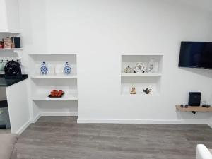 a living room with white walls and white shelves at Apartment in Semeador in Portalegre +23 photos