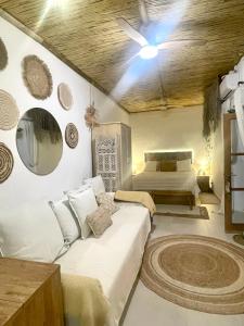 a bedroom with two beds and a ceiling fan at Arcos de Tarifa, Casco historico in Tarifa