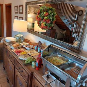 a buffet with a sink and a mirror at Pensjonat Poranna Rosa in Grabowiec