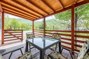 a screened porch with a glass table and chairs at Holy Hills in Sveti Rok