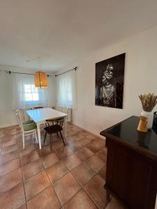 a living room with a table and a dining room at Boho Home am Bach in Altmünster