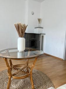 a glass table with a vase on top of it at Boho Home am Bach in Altmünster