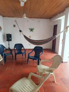 een groep stoelen en een hangmat in een kamer bij Hospedaje Doña Victoria in Santa Marta
