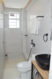 Executive Two & Three Bedroom Suites في ناكورو: حمام ابيض مع مرحاض ومغسلة