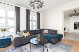 a living room with a couch and a table at Hilltop Apartments - City Centre in Tallinn