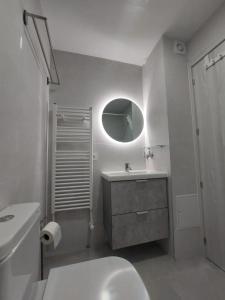 a bathroom with a toilet and a sink and a mirror at Reina Doña Urraca in Palencia