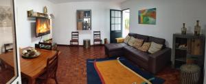 a living room with a couch and a table at Casa Ascenção, vista mar Madeira in Funchal