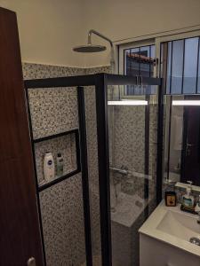 a bathroom with a shower and a sink at Casa Ascenção, vista mar Madeira in Funchal