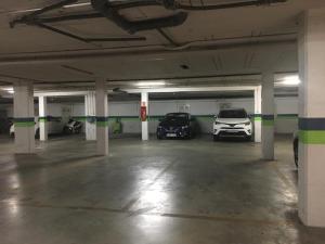 a parking garage with two cars parked in it at Áncora apartamento in El Puerto de Santa María