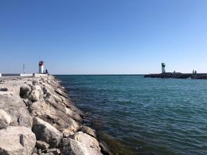 a rocky shore with two lighthouses in the water at Comfy 2 Bedroom Near The Beach! in Pickering
