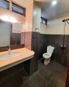 a bathroom with a sink and a toilet at Anabi Apartments and Suits E11 Islamabad in Islamabad
