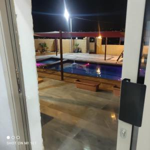 a view of a swimming pool at night at Raghad Chalet in Jerash