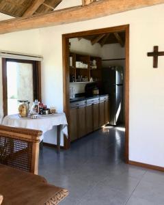 a kitchen with a white table and a refrigerator at Casa de campo in Rivera