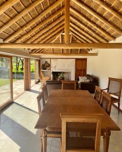 a dining room with a table and a fireplace at Casa de campo in Rivera