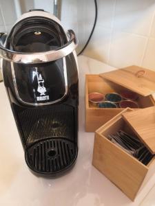 a blender sitting on a counter next to a box of donuts at Apartment La Marina near the sea in Varazze