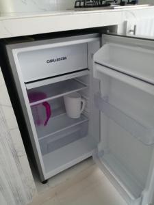 a refrigerator with its door open with a cup in it at Estudio tipo Loft Amoblado en Bocagrande Cartagena 801A in Cartagena de Indias