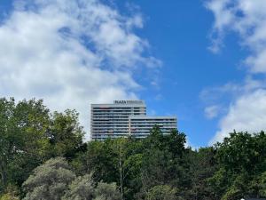 a tall building with a sign on top of trees at Appartment bezaubernder Landblick in Timmendorfer Strand