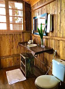 baño de madera con aseo y lavamanos en Casa Eliza, casa de luxo com vista mar, en Trancoso
