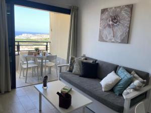 a living room with a couch and a table at Relax And Sunset in Paraiso Adeje in Adeje