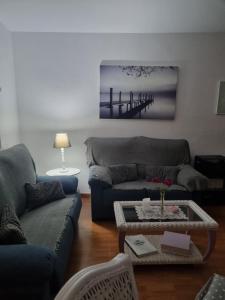 a living room with a couch and a table at Sol y Luz in Isla del Moral