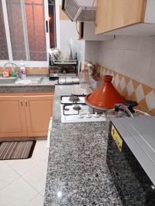 a kitchen with a stove with a tea pot on it at أكادير حي السلام in Agadir