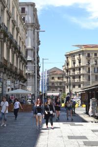 a group of people walking down a city street at Hotel Cineholiday in Naples