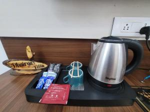 a coffee maker sitting on top of a table at Dhairya's Villa Home Away From Home in Jammu